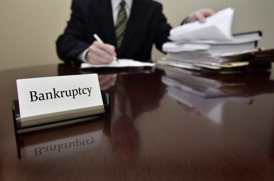 Bankruptcy attorney or accountant sitting at desk with files and papers
